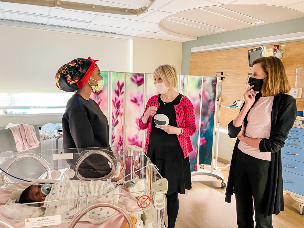 April Benasich and Julia Whitehead speaking to a nurse at the UPMC NICU